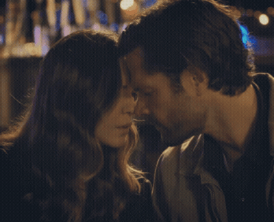 A Man And A Woman Are Kissing With Their Eyes Closed GIF