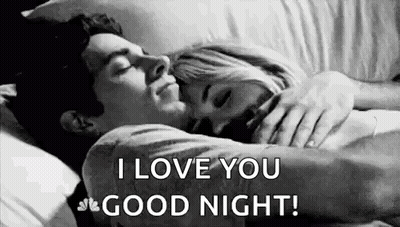 A Man And A Woman Are Laying In Bed Hugging Each Other And The Man Is Saying `` I Love You Good Night '' . GIF