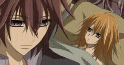 A Man And A Woman Are Laying In Bed Together . GIF