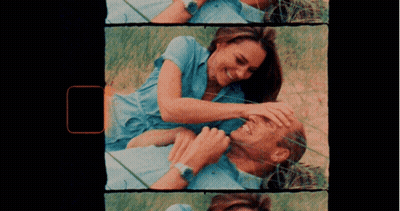 A Man And A Woman Are Laying In The Grass GIF