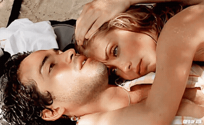 A Man And A Woman Are Laying On A Beach With The Words Gifs Of Ata On The Bottom Right GIF
