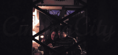 A Man And A Woman Are Laying On A Bed With A Canopy GIF