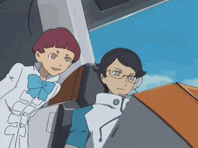 A Man And A Woman Are Looking At A Computer Screen GIF