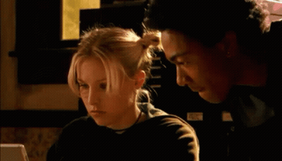 A Man And A Woman Are Looking At A Computer Screen And The Woman Is Saying " Ruh Roh " GIF
