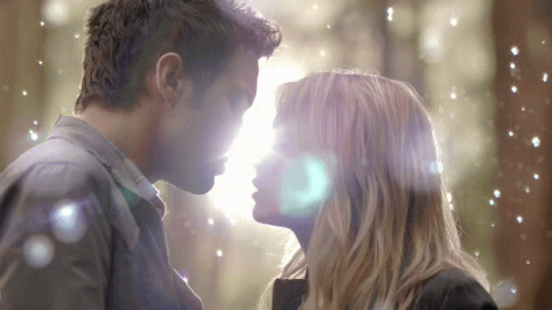A Man And A Woman Are Looking At Each Other GIF