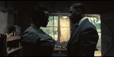 A Man And A Woman Are Looking At Each Other GIF