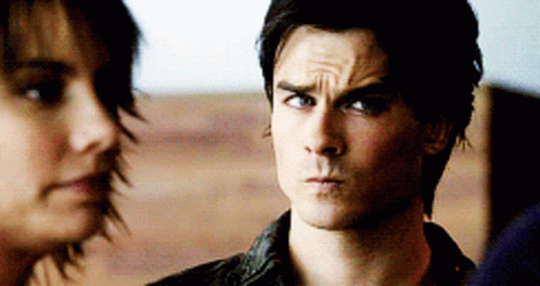A Man And A Woman Are Looking At Each Other And The Man Is Making A Funny Face GIF