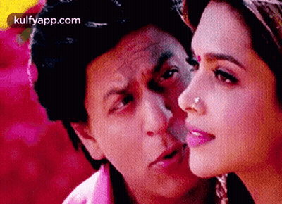 A Man And A Woman Are Looking At Each Other And The Woman Has A Nose Ring . GIF