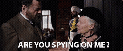 A Man And A Woman Are Looking At Each Other And The Woman Is Asking The Man If He Is Spying On Her . GIF