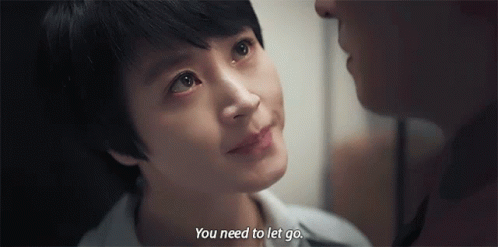 A Man And A Woman Are Looking At Each Other And The Woman Is Crying . GIF