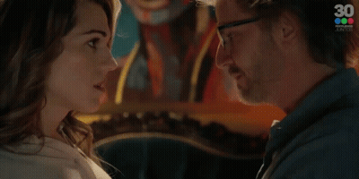 A Man And A Woman Are Looking At Each Other And The Woman Is Saying Contestame GIF