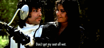 A Man And A Woman Are Looking At Each Other And The Woman Says " Don T Get My Seat All Wet " GIF