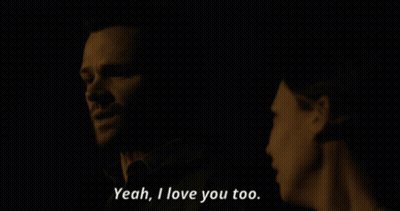 A Man And A Woman Are Looking At Each Other And The Woman Says Yeah I Love You Too GIF