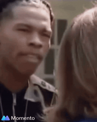 A Man And A Woman Are Looking At Each Other And The Word Momento Is On The Bottom Of The Screen GIF