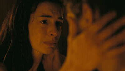 A Man And A Woman Are Looking At Each Other GIF