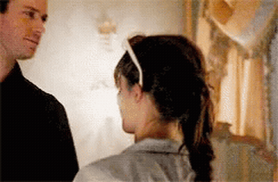 A Man And A Woman Are Looking At Each Other . GIF