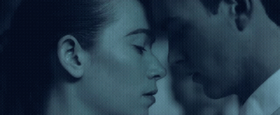 A Man And A Woman Are Looking At Each Other GIF