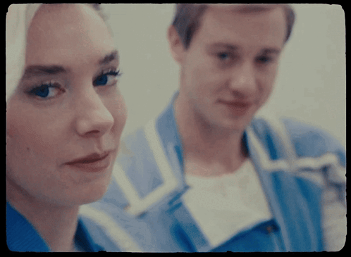 A Man And A Woman Are Looking At Each Other In A Blurry Photo GIF