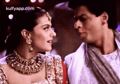 A Man And A Woman Are Looking At Each Other In A Close Up . GIF