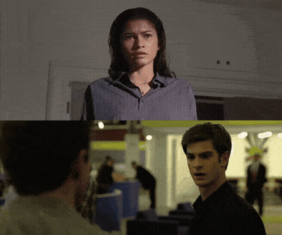 A Man And A Woman Are Looking At Each Other In A Dark Room GIF