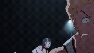 A Man And A Woman Are Looking At Each Other In A Dark Room With A Light Behind Them GIF
