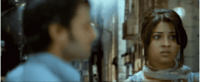 A Man And A Woman Are Looking At Each Other In A Movie Screen Shot GIF
