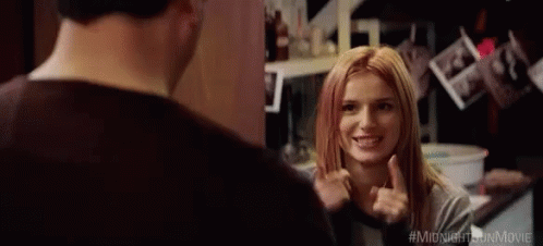 A Man And A Woman Are Looking At Each Other In A Room And The Woman Is Pointing At The Man . GIF
