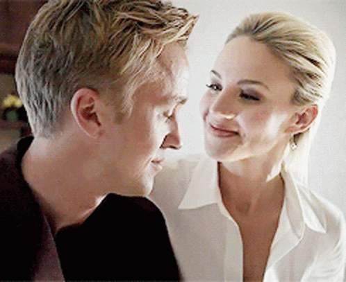 A Man And A Woman Are Looking At Each Other GIF