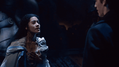 A Man And A Woman Are Looking At Each Other GIF