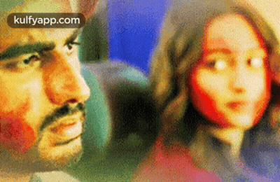 A Man And A Woman Are Looking At Each Other On A Plane . GIF