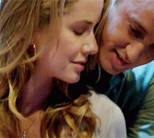 A Man And A Woman Are Looking At Each Other GIF