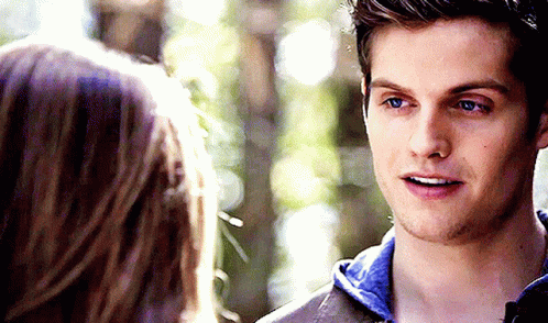 A Man And A Woman Are Looking At Each Other GIF