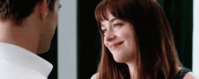 A Man And A Woman Are Looking At Each Other . The Woman Is Smiling And The Man Is Looking At Her . GIF