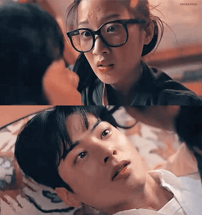 A Man And A Woman Are Looking At Each Other . The Woman Is Wearing Glasses . GIF