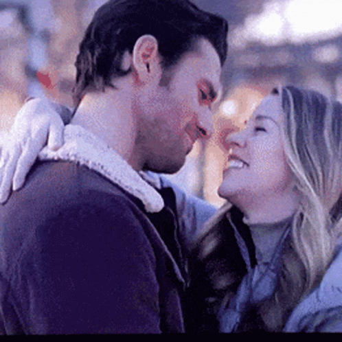 A Man And A Woman Are Looking At Each Other . GIF