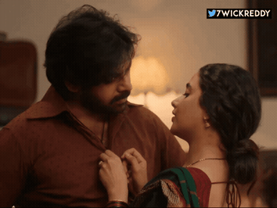 A Man And A Woman Are Looking At Each Other With A 7Wickreddy Sticker In The Corner GIF