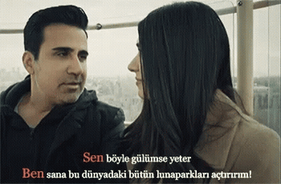 A Man And A Woman Are Looking At Each Other With A Caption In A Language Other Than English GIF