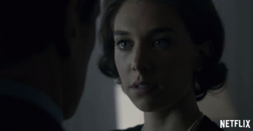 A Man And A Woman Are Looking At Each Other With A Netflix Logo In The Foreground GIF