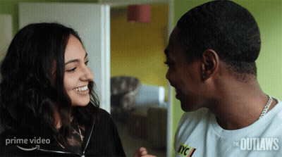 A Man And A Woman Are Looking At Each Other With A Prime Video Logo In The Background GIF
