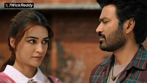A Man And A Woman Are Looking At Each Other With A X7wick Reddy Logo In The Background GIF