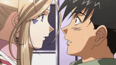 A Man And A Woman Are Looking At Each Other With The Letter N Visible On Their Foreheads GIF