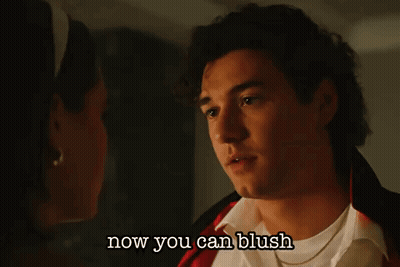 A Man And A Woman Are Looking At Each Other With The Words Now You Can Blush Below Them GIF