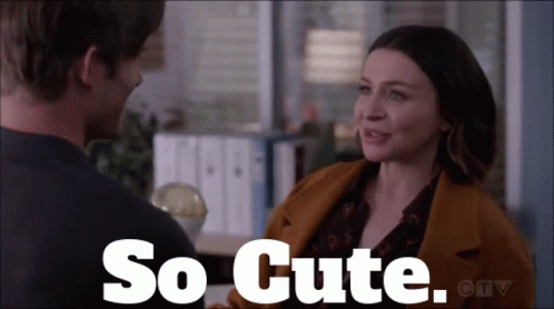 A Man And A Woman Are Looking At Each Other With The Words So Cute Written Above Them GIF