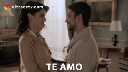 A Man And A Woman Are Looking At Each Other With The Words Te Amo Written Above Them GIF