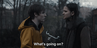A Man And A Woman Are Looking At Each Other With The Words What 'S Going On GIF