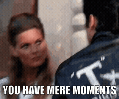 A Man And A Woman Are Looking At Each Other With The Words " You Have Mere Moments " Below Them GIF