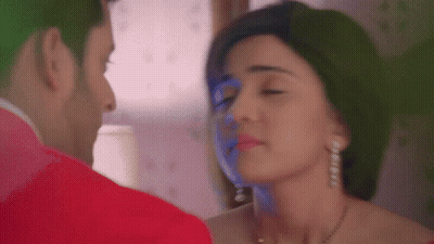 A Man And A Woman Are Looking At Each Other With Their Eyes Closed . GIF