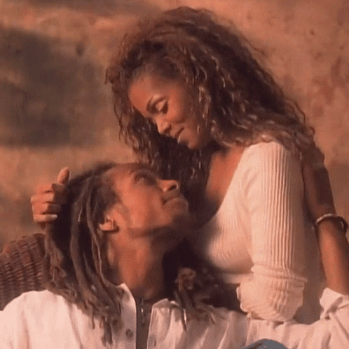 A Man And A Woman Are Looking At Each Other With Their Eyes Closed GIF