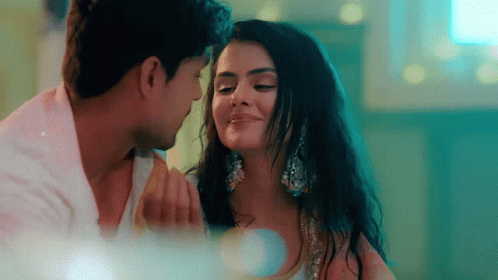 A Man And A Woman Are Looking At Each Other With Their Eyes Closed . GIF