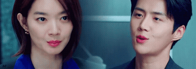 A Man And A Woman Are Looking At Each Other With Their Eyes Closed . GIF